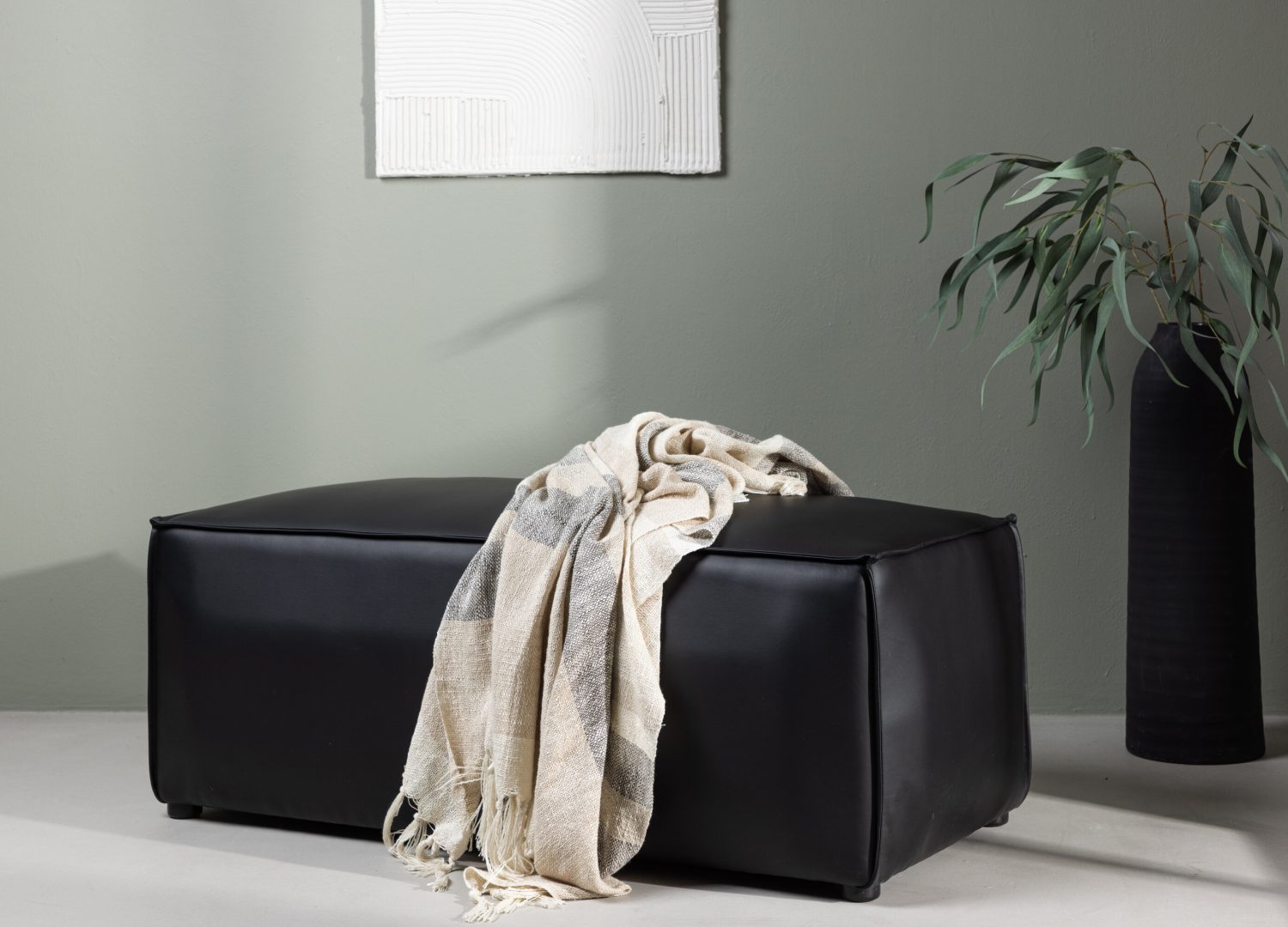 Pouf Palermo similicuir en polyuréthane noir 59 cm mis en scène dans un intérieur