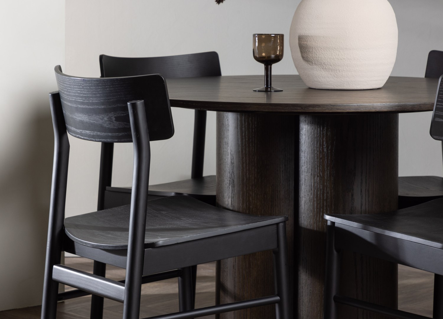 Table ronde Olivia et 4 chaises Montros présentées dans un intérieur contemporain